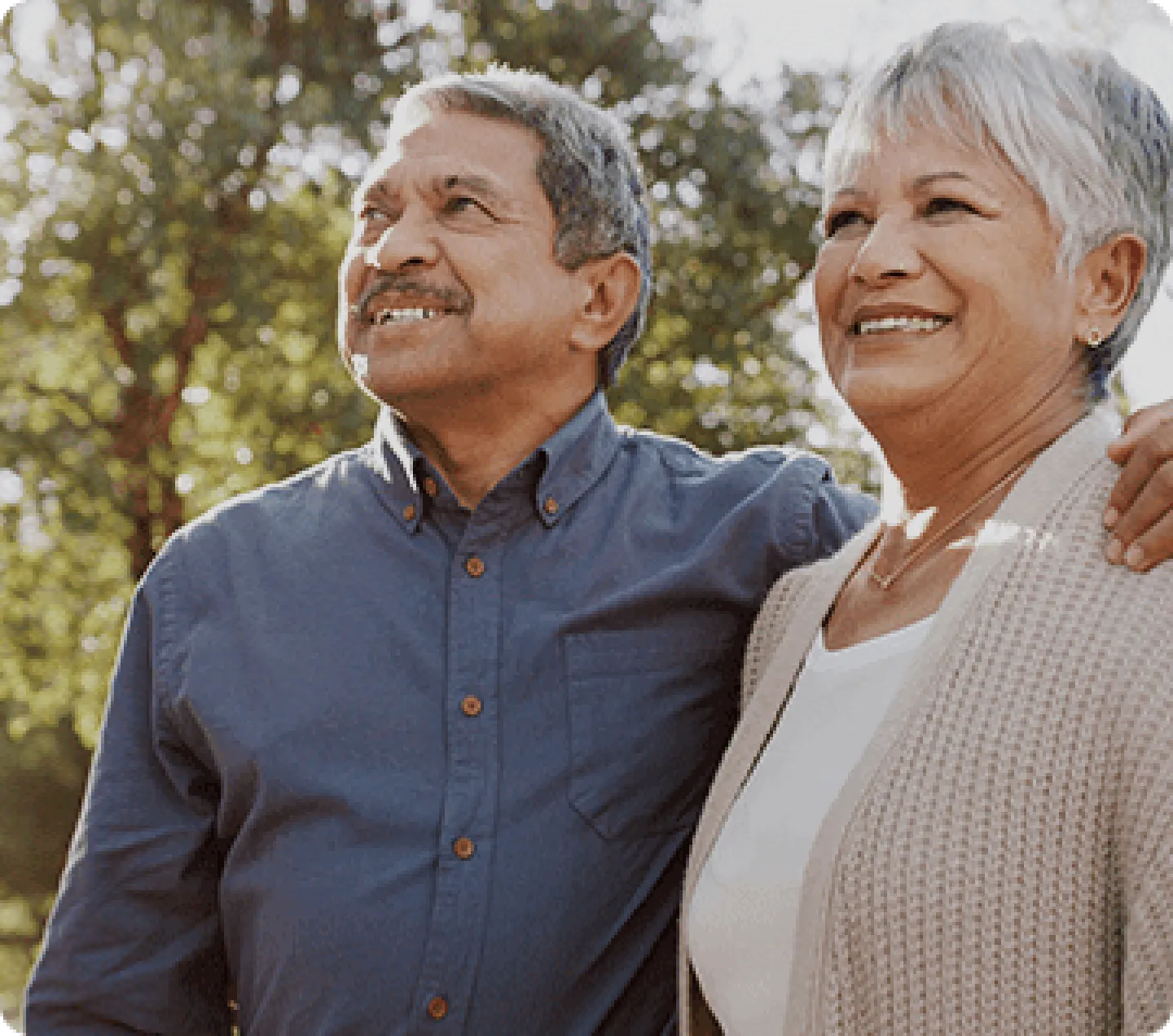 An older couple smiling outside
