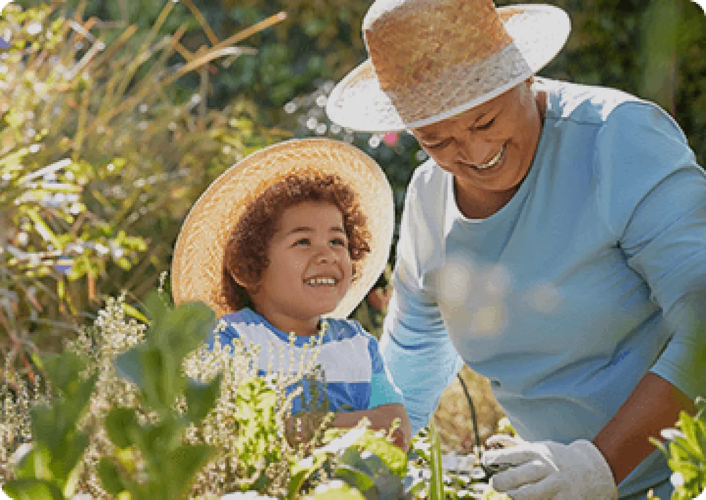 An older woman and her grandson outside smiling